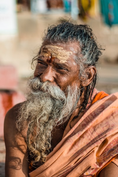 Selective focus pictures of a man wearing orange clothes
